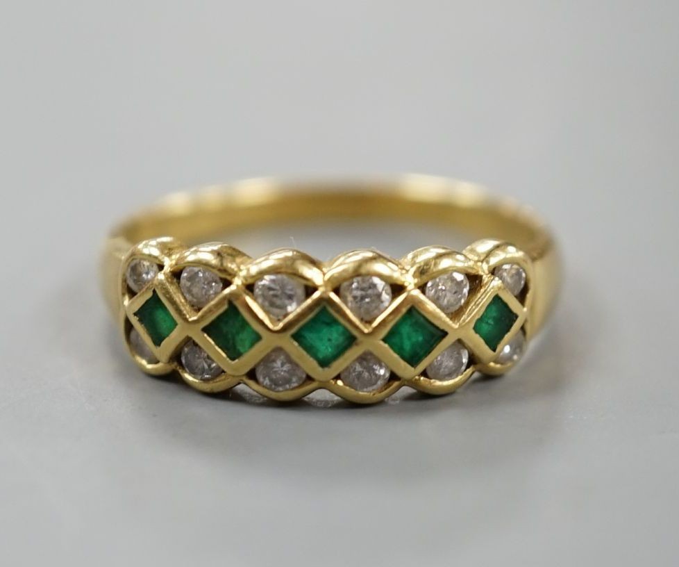 A modern 18ct gold, emerald and diamond line cluster set half hoop ring, size R, gross 3.9 grams.